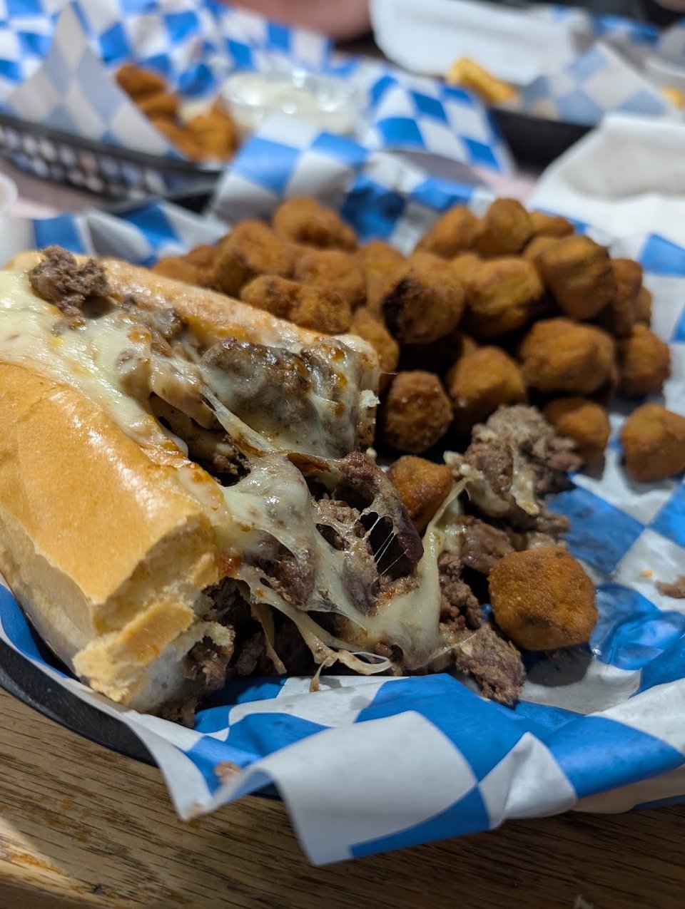 Menu board with subs, burgers, and appetizers.